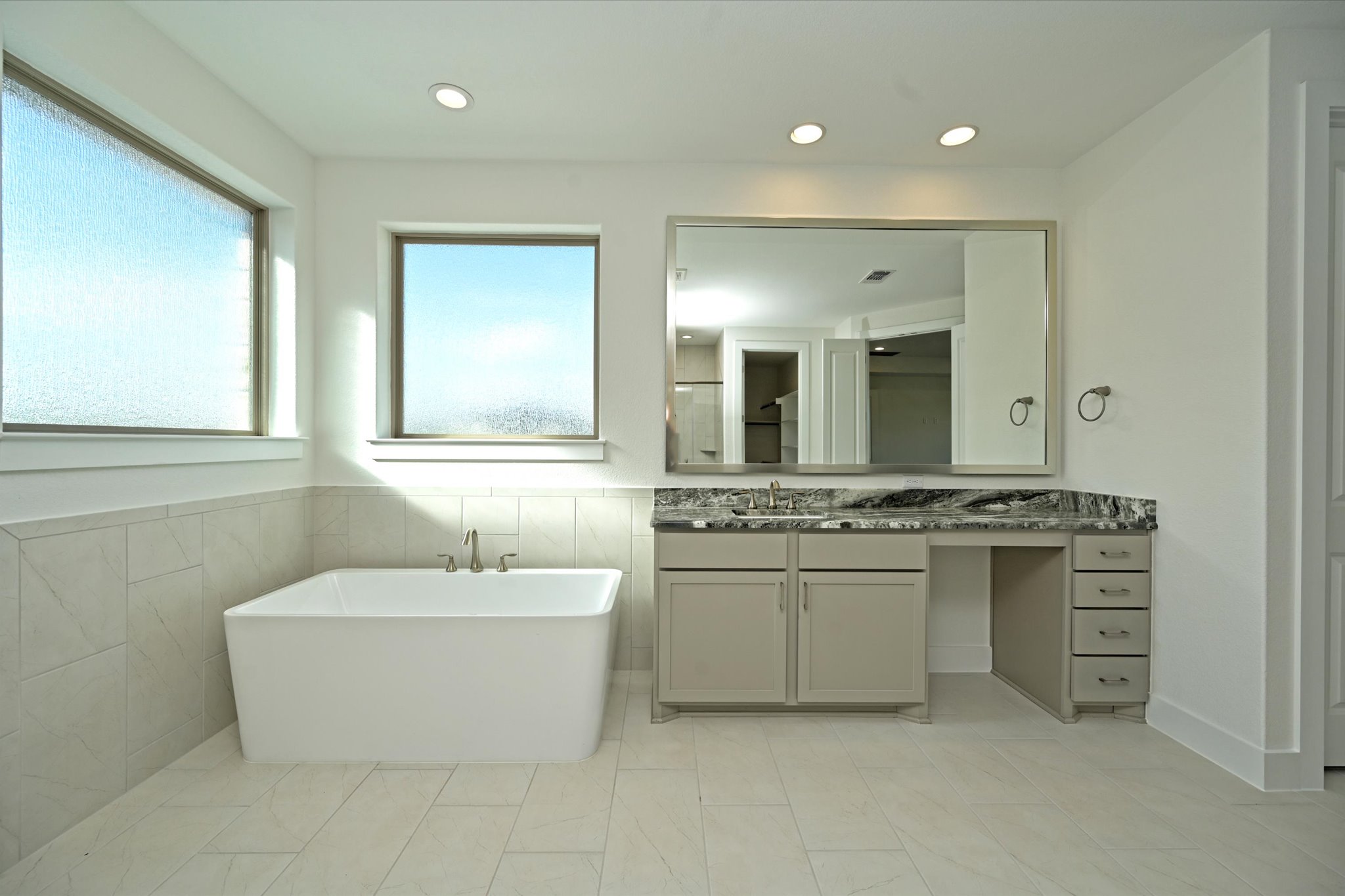 209 Scofield Avenue Georgetown, TX 78626 - Photo 19 of 33 a spacious bathroom with a double vanity sink a mirror and a bathtub