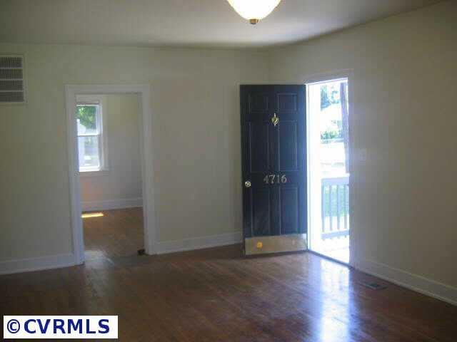 4716 Cooks Road Richmond, VA 23224 - Photo 5 of 10 Other - 20 x 15 living room with wood floors, two windows & pass thru to kitchen