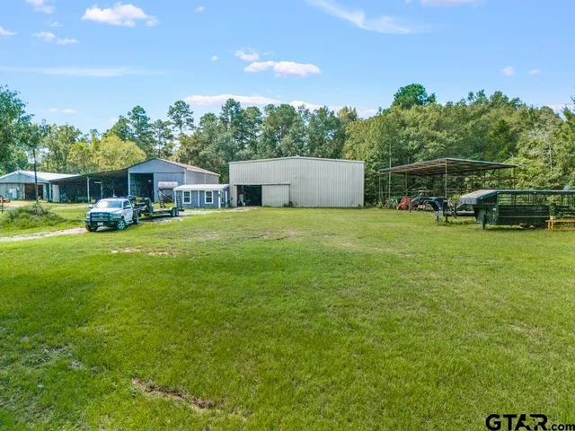 a view of a house with a yard and sitting area