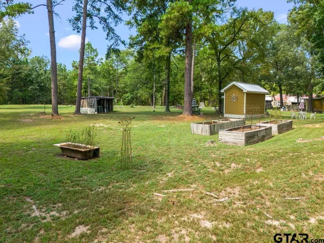 a swimming pool with outdoor seating and yard