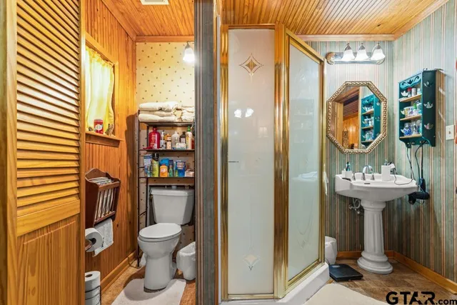 a bathroom with a toilet and a shower curtain