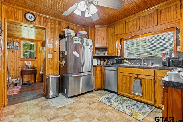 a kitchen with stainless steel appliances granite countertop a refrigerator and a sink