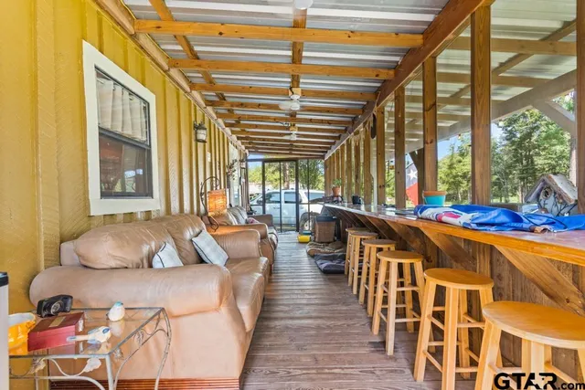 a living room with furniture and a floor to ceiling window