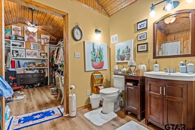 a view of walk in closet with clothes