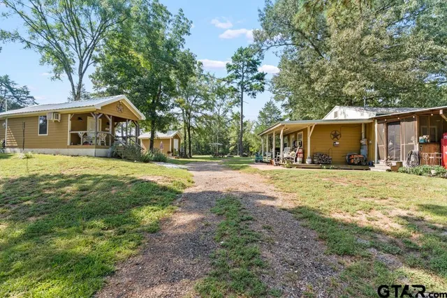 a view of backyard with a table and chairs and wooden fence