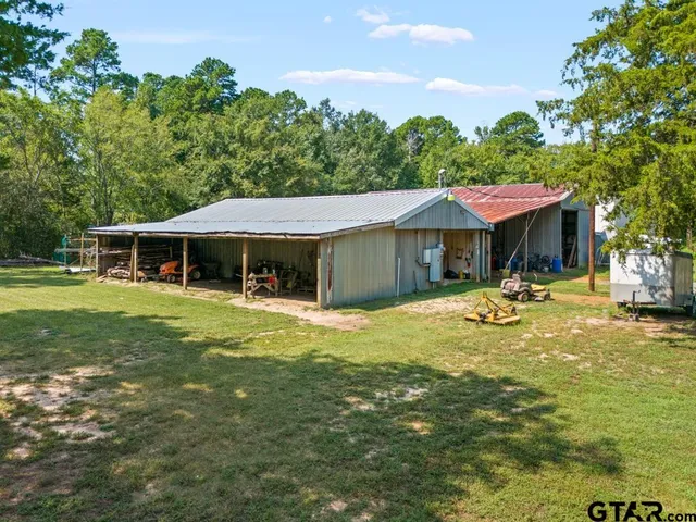 a view of a house with pool and chairs