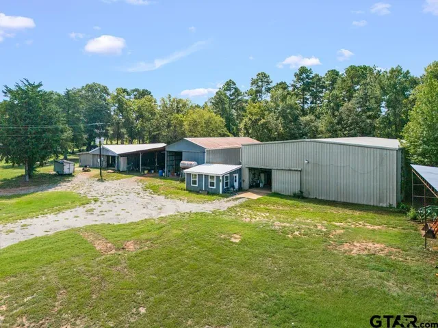 a view of a house with pool and a yard