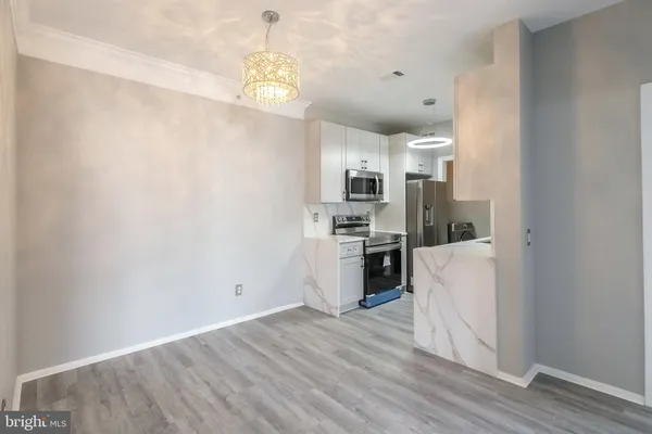 a view of kitchen with cabinets and wooden floor