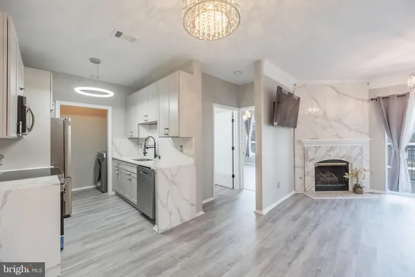 a view of kitchen with sink microwave and refrigerator