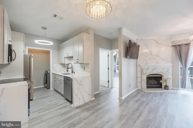 a view of kitchen with sink microwave and refrigerator