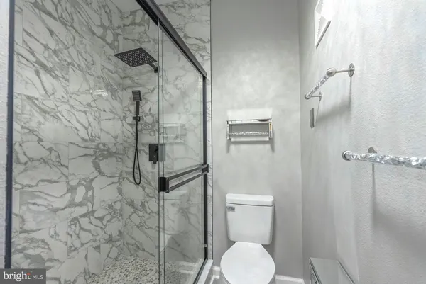 a view of a hallway with wooden floor and a chandelier