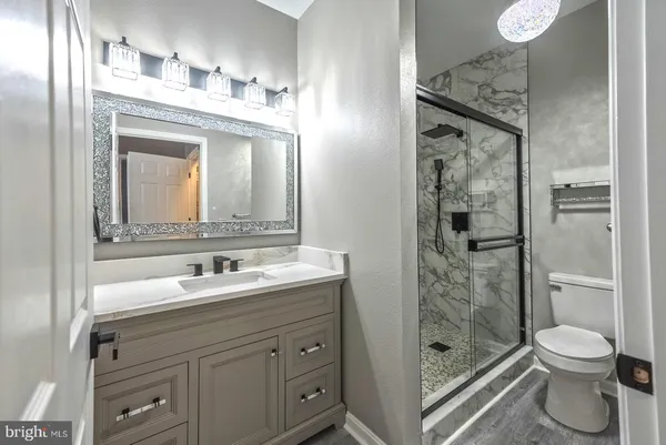 a bathroom with a toilet sink and shower