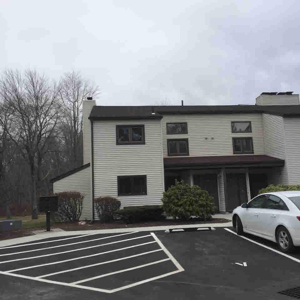 a view of a car park in front of house