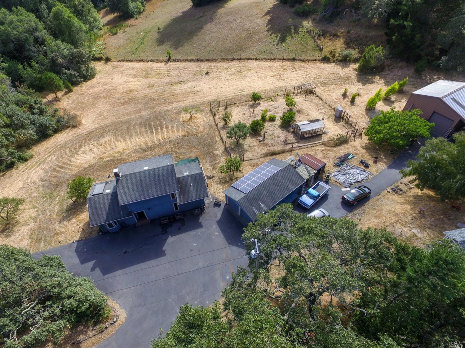 Beautiful home with pastoral views, many outbuildings, including a large shop with loft and RV parking.
