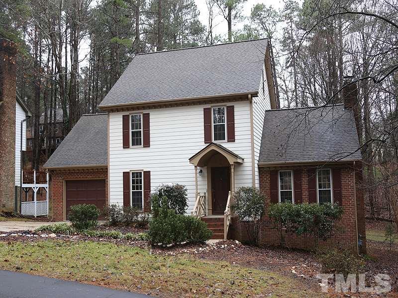 11957 Eagle Cliff Court Raleigh, NC 27613 - Photo 1 of 25 a front view of a house with garden and plants