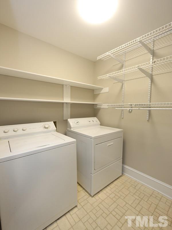 11957 Eagle Cliff Court Raleigh, NC 27613 - Photo 11 of 25 a utility room with dryer and washer