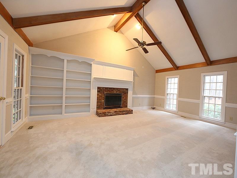 11957 Eagle Cliff Court Raleigh, NC 27613 - Photo 12 of 25 a view of an empty room with a fireplace and a window
