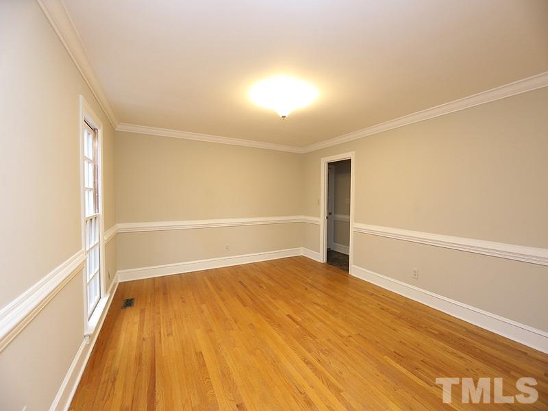 11957 Eagle Cliff Court Raleigh, NC 27613 - Photo 3 of 25 a view of an empty room with wooden floor and a window