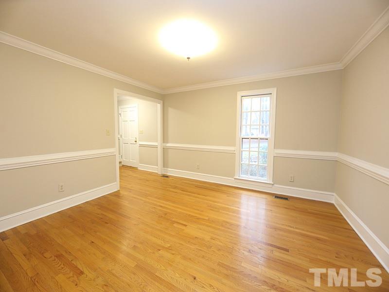 11957 Eagle Cliff Court Raleigh, NC 27613 - Photo 4 of 25 a view of an empty room with wooden floor and a window