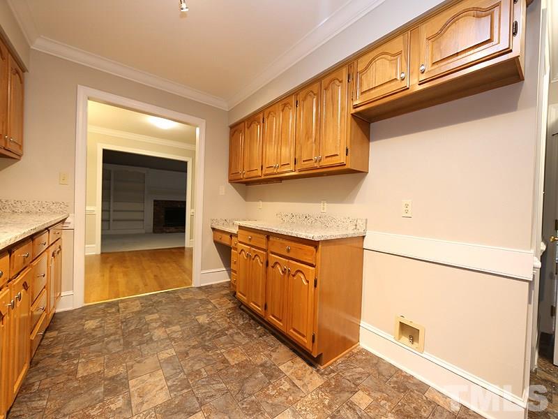 11957 Eagle Cliff Court Raleigh, NC 27613 - Photo 6 of 25 a kitchen with stainless steel appliances granite countertop a stove a sink and a refrigerator
