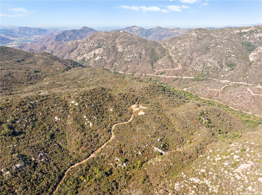 0 Pala Temecula Rd Valley Center Pala, CA 92059 - Photo 1 of 1 a view of a mountain range in a cloudy sky