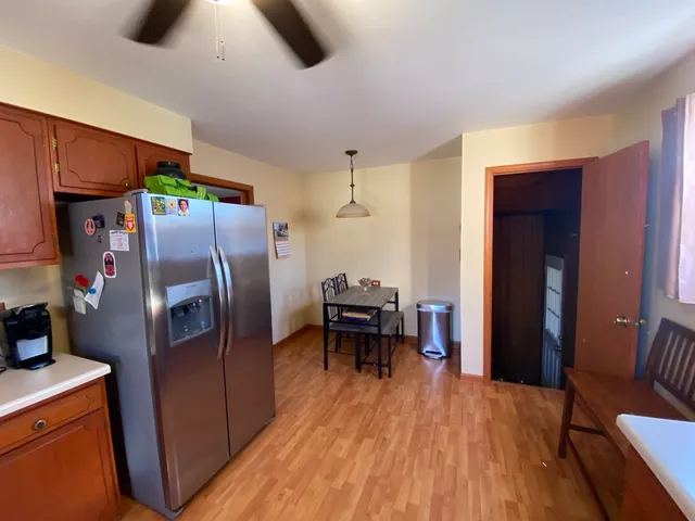 a kitchen with stainless steel appliances granite countertop a refrigerator and a stove top oven