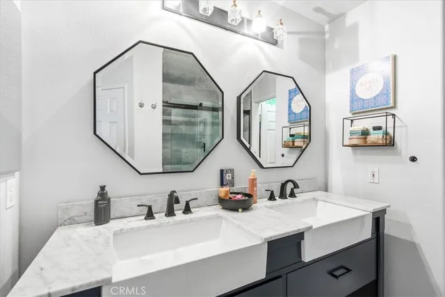 a bedroom with a bed and a refrigerator