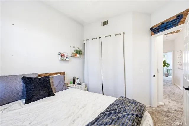a bedroom with a bed and cabinets