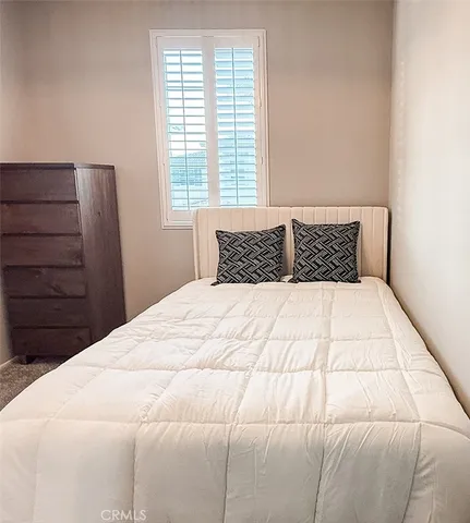 a bedroom with a bed and window