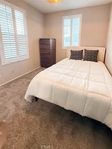 a view of a patio with chairs and potted plants