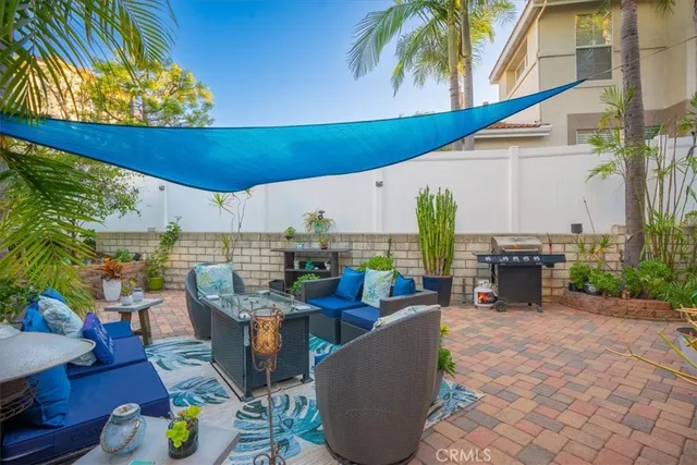 a view of a patio with plants and chairs