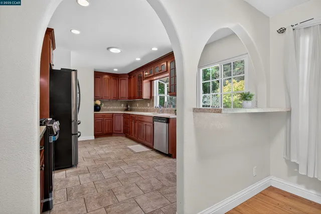 a kitchen with stainless steel appliances granite countertop a refrigerator sink and cabinets