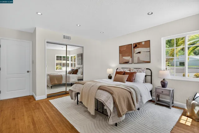 a bedroom with a bed and a large window