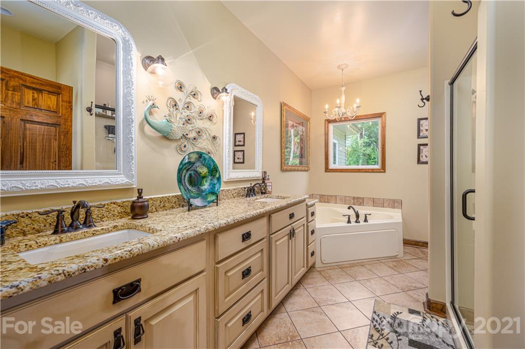 4773 Grigg Road Lincolnton, NC 28092 - Photo 12 of 34 a spacious bathroom with a granite countertop tub sink and mirror