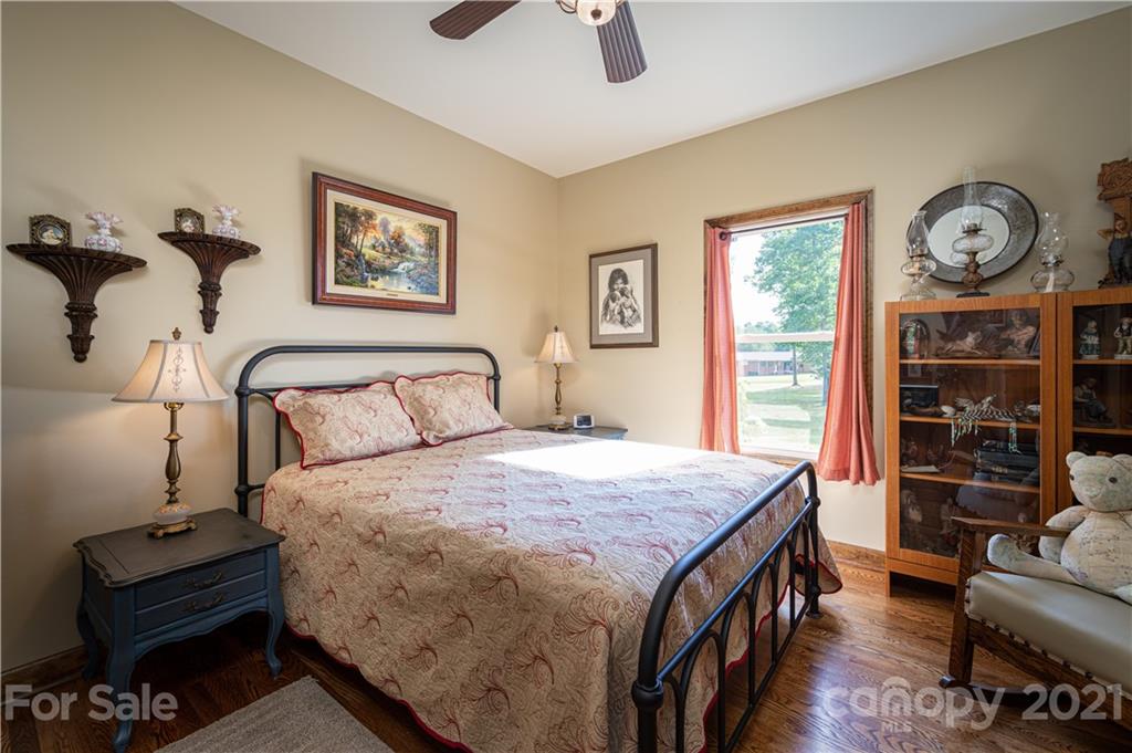 4773 Grigg Road Lincolnton, NC 28092 - Photo 14 of 34 a spacious bedroom with a bed a dresser and book shelf