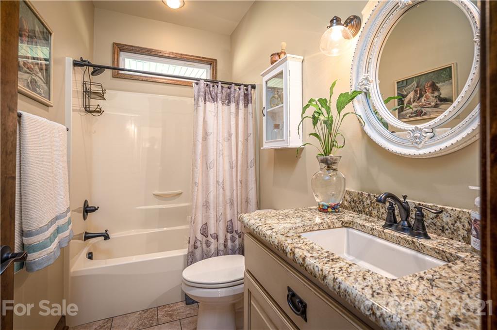 4773 Grigg Road Lincolnton, NC 28092 - Photo 17 of 34 a bathroom with a granite countertop sink and a mirror