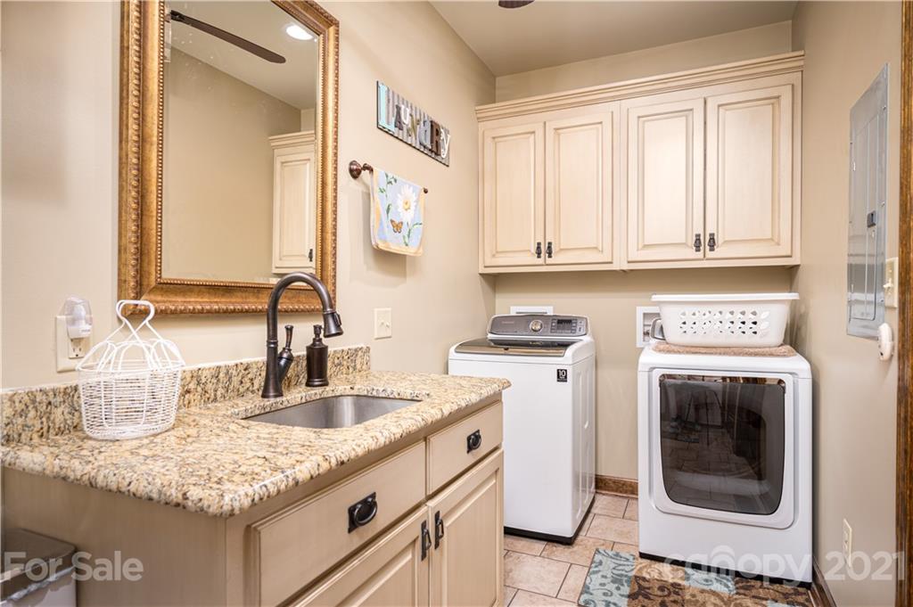 4773 Grigg Road Lincolnton, NC 28092 - Photo 19 of 34 a kitchen with granite countertop a sink and white cabinets