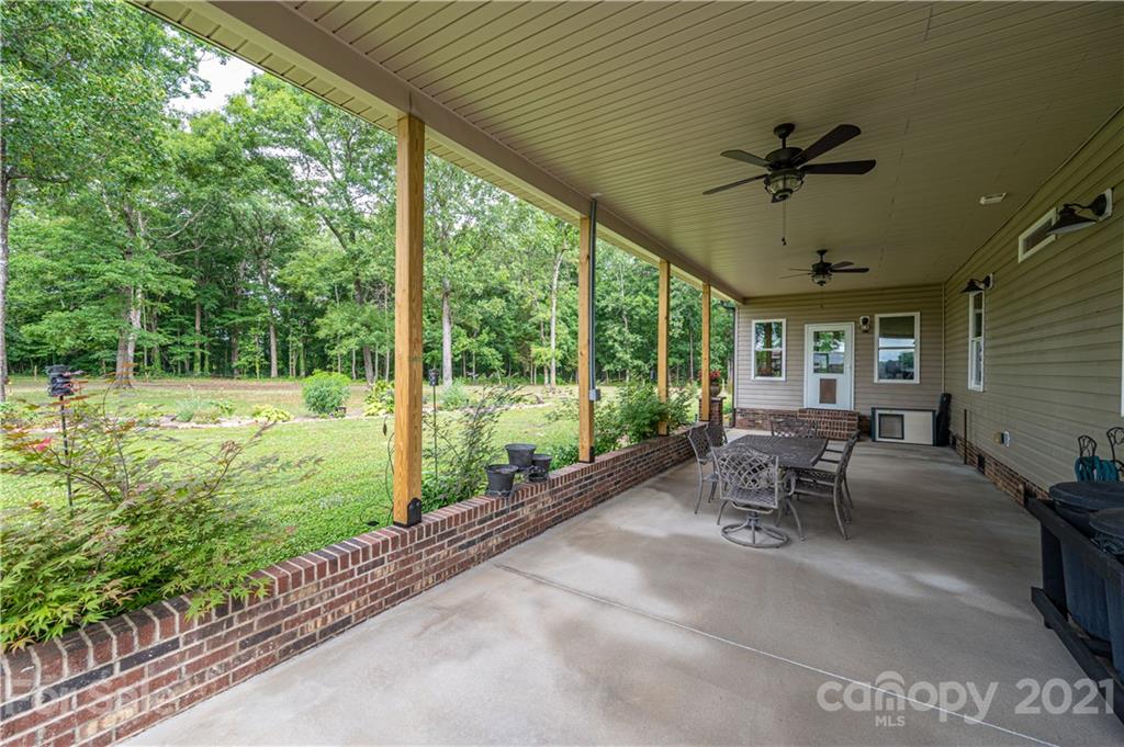4773 Grigg Road Lincolnton, NC 28092 - Photo 21 of 34 a view of a porch with chairs and backyard