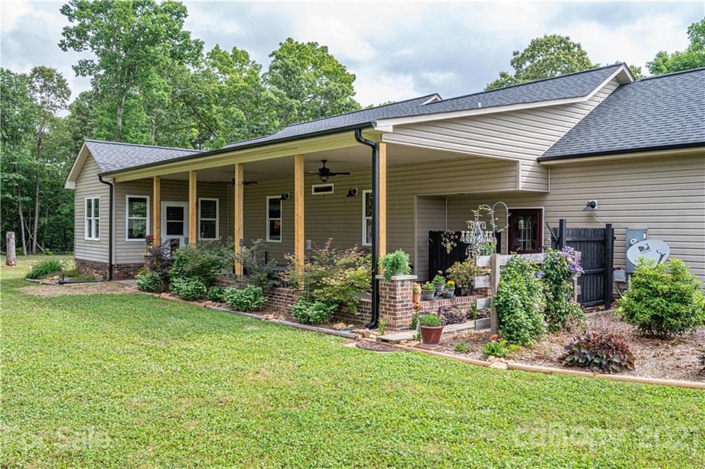 4773 Grigg Road Lincolnton, NC 28092 - Photo 24 of 34 a view of a house with backyard sitting area and garden