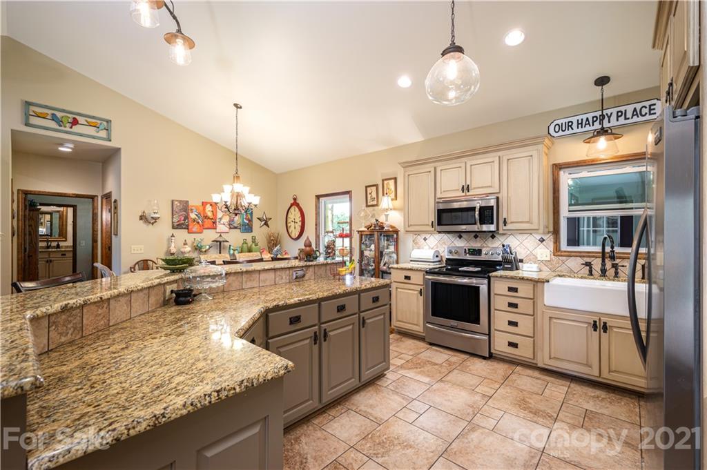 4773 Grigg Road Lincolnton, NC 28092 - Photo 7 of 34 a kitchen with stainless steel appliances granite countertop a sink counter space cabinets and a stove