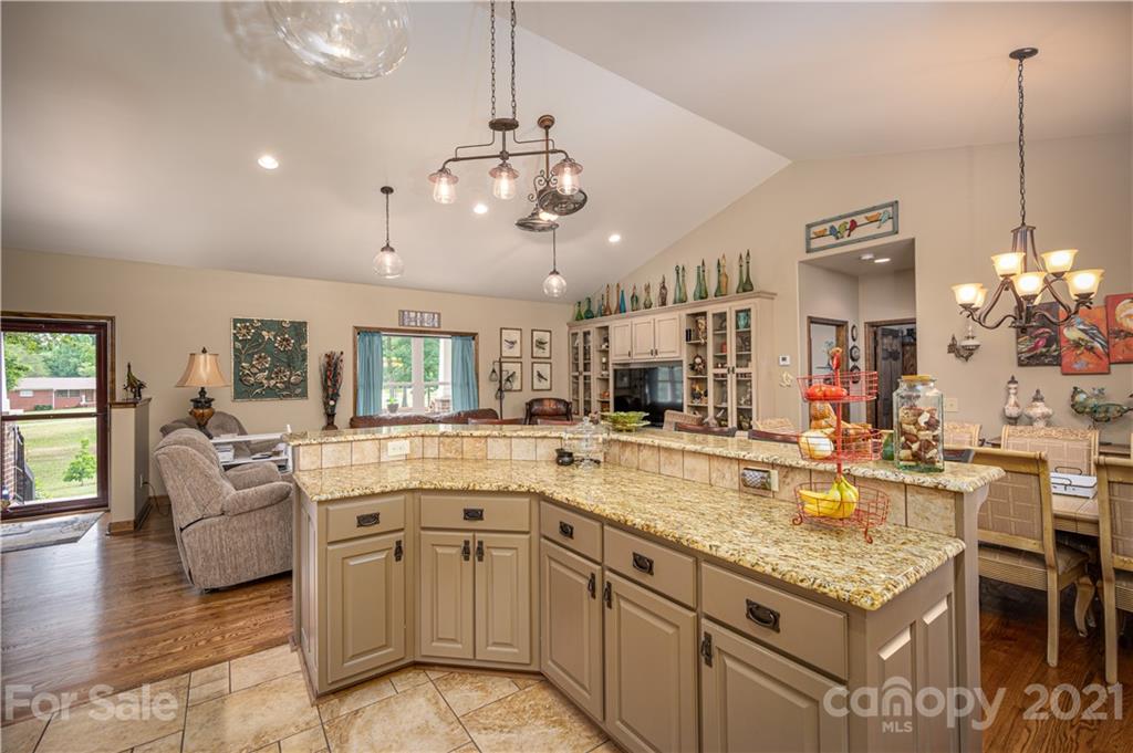 4773 Grigg Road Lincolnton, NC 28092 - Photo 8 of 34 a large kitchen with kitchen island a large counter space and stainless steel appliances
