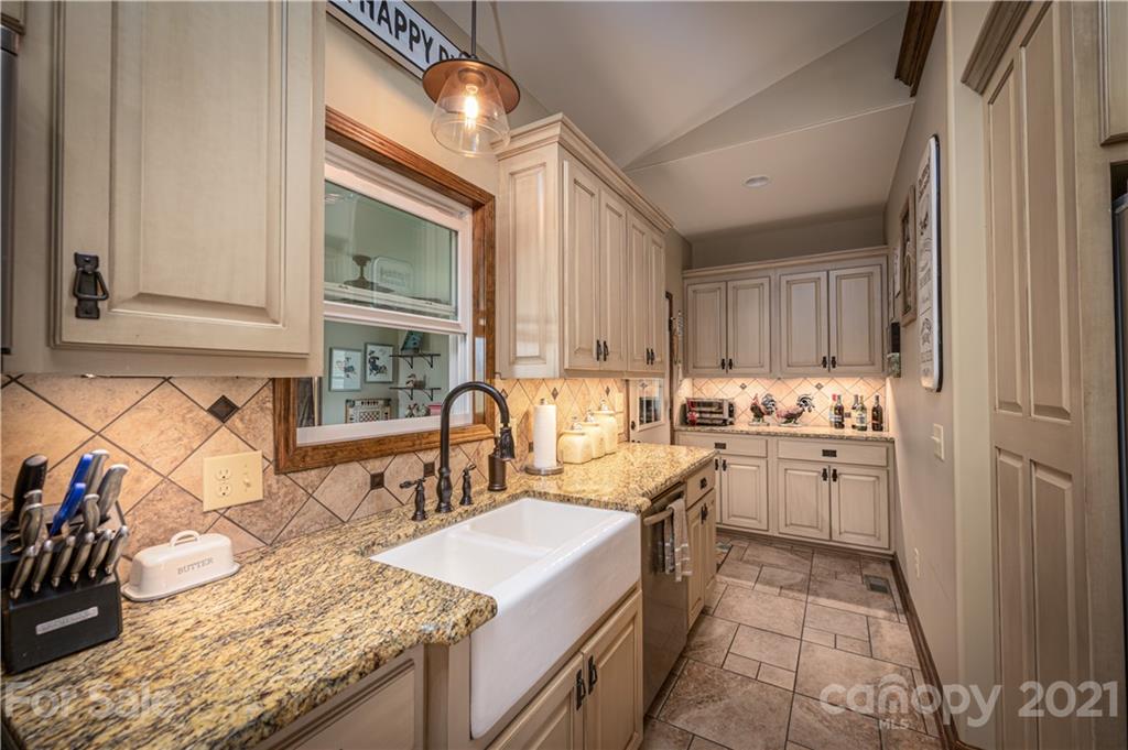 4773 Grigg Road Lincolnton, NC 28092 - Photo 9 of 34 a kitchen with a sink stove and cabinets