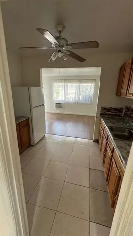 a kitchen with a stove a refrigerator and a stove top oven