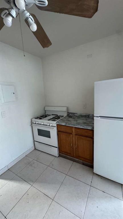 750 83rd Street, Unit 3 Miami Beach, FL 33141 - Photo 16 of 31 a kitchen with a stove top oven and cabinets