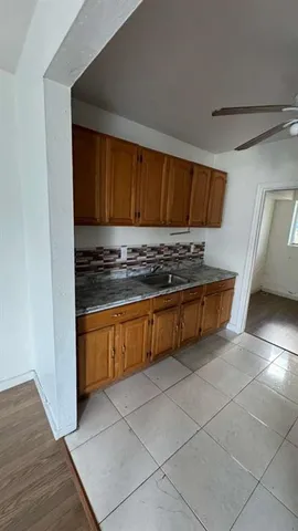 a kitchen with stainless steel appliances a stove a sink and a refrigerator