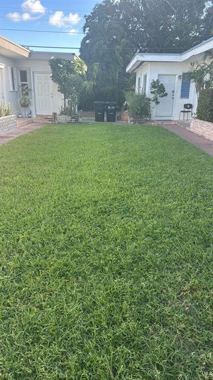 750 83rd Street, Unit 3 Miami Beach, FL 33141 - Photo 22 of 31 a view of house with backyard and outdoor seating