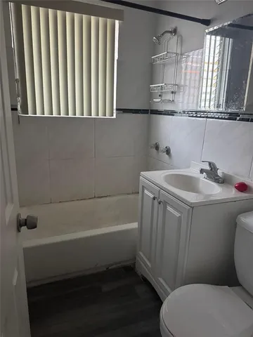 a bathroom with a sink a toilet and bathtub