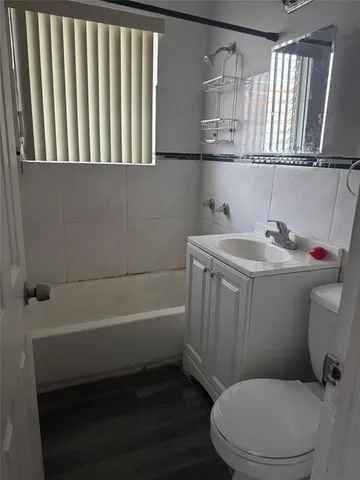 a bathroom with a sink a toilet and bathtub