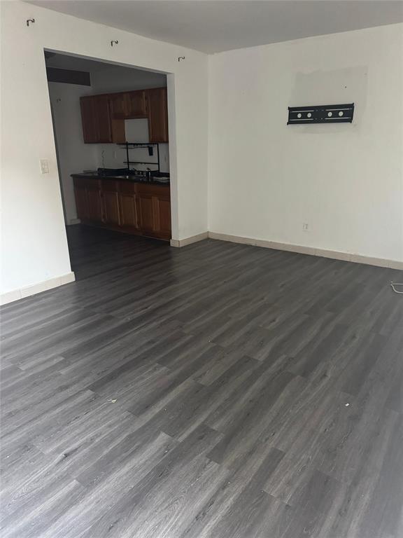 750 83rd Street, Unit 3 Miami Beach, FL 33141 - Photo 30 of 31 a kitchen with stainless steel appliances wooden floors and wooden cabinets