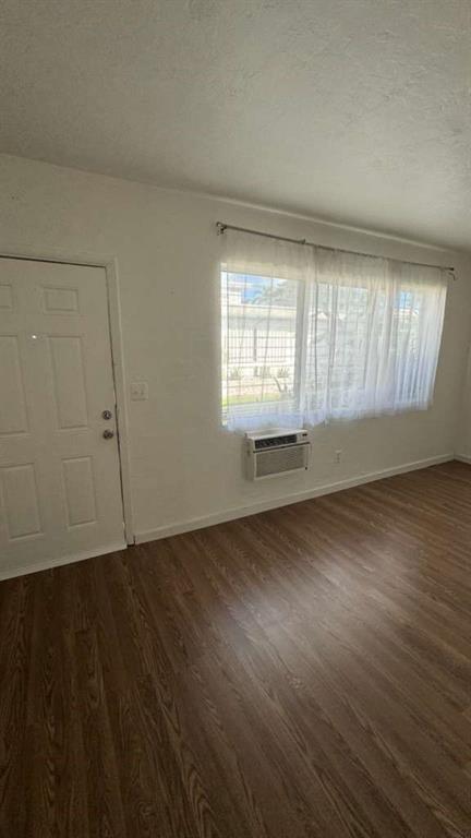 750 83rd Street, Unit 3 Miami Beach, FL 33141 - Photo 7 of 31 an empty room with wooden floor and windows